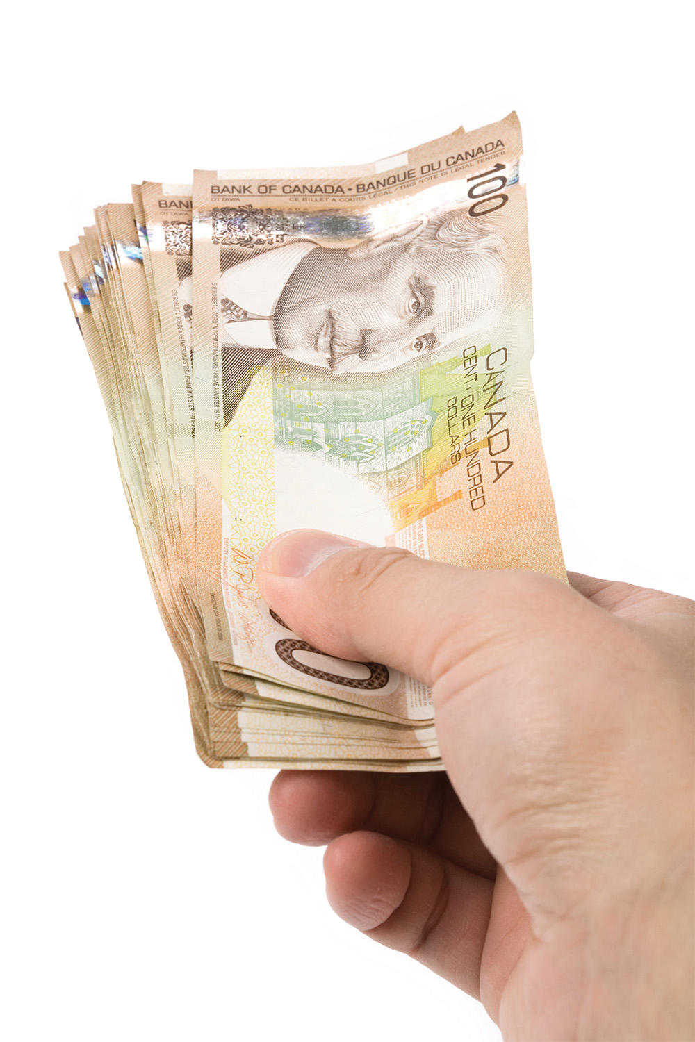 a hand full of canadian dollars | Canadian Contractor