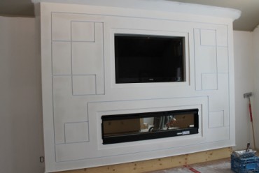 This fireplace/TV nook was built from steel stud, double layers of scrap drywall, reveals, beading, radius j trim.