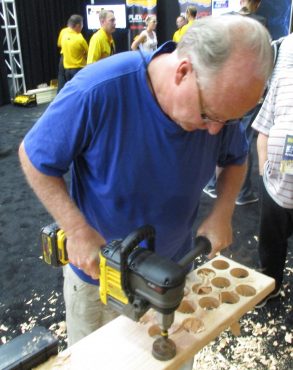 John Bleasby effortlessly rips holes through 1 3/4" board with a DeWalt hole cutter powered by the new FlexVolt system at one of the many hands-on stations