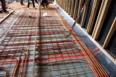 Radiant floor tubing, installed over a new sub floor, insulated with foam board