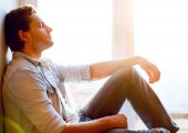 Man enjoying peace and quiet by a window