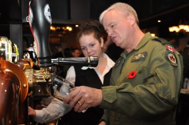 Commander Colin Keiver tries a sample of the brew at the Earl of Bessborough Social House opening (photo: Nick Roy/Bryck Productions)